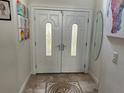 Bright entryway with double doors and decorative tile floor at 2213 Mallory Cir, Haines City, FL 33844