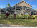 House with screened patio and landscaped backyard at 2213 Mallory Cir, Haines City, FL 33844