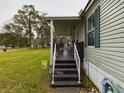Covered porch and steps leading to the home's entrance at 5490 Morgan Rd, Lakeland, FL 33810