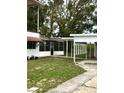 Screened porch with access to the backyard and carport at 34 Pine Rd, Babson Park, FL 33827