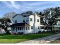 Two-story white house with a long driveway and carport at 34 Pine Rd, Babson Park, FL 33827