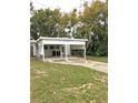 White carport with a concrete floor and surrounding yard at 34 Pine Rd, Babson Park, FL 33827
