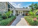 Brick paved walkway to double front doors of a home with lush landscaping at 514 Hillside Dr, Auburndale, FL 33823