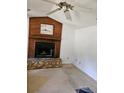 Living room with a fireplace and ceiling fan at 4450 Old Berkley Rd, Auburndale, FL 33823