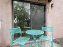 Small patio with teal metal table and chairs at 104 La Casa # 104, Lake Wales, FL 33898
