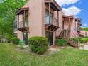 Two-story condo building with private balconies and American flag at 104 La Casa # 104, Lake Wales, FL 33898