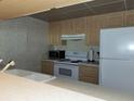 View of kitchen with white appliances and wood cabinets at 4171 Abbey Ct # 4171, Haines City, FL 33844