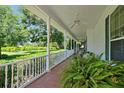 Spacious front porch with seating and plants at 1242 11Th Ne St, Winter Haven, FL 33881