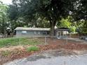 Gray house exterior with screened porch and fenced yard at 152 E Grove Dr, Haines City, FL 33844