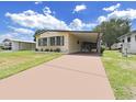 Charming single-story home with carport and landscaping at 1606 Tally Ho Dr, Lakeland, FL 33810