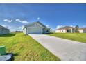 Newly built home with a long driveway and a neatly landscaped yard at 4073 Tullamore Ln, Auburndale, FL 33823
