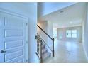 Bright entryway with staircase, tile flooring, and coat closet at 1405 Leamington Ln, Winter Haven, FL 33884