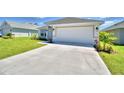 Newly constructed home with a driveway and landscaping at 2123 Cartgate Lane, Winter Haven, FL 33884