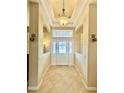 Elegant entryway with tiled floors and a chandelier at 1876 Eloise Cove Dr, Winter Haven, FL 33884