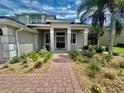 Front entrance with brick pathway and lush landscaping at 1876 Eloise Cove Dr, Winter Haven, FL 33884