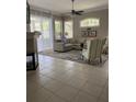 Spacious living room with a fireplace and large windows at 102 Jardin Ln, Winter Haven, FL 33884