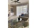 Living room with tile floors, sectional sofa, and access to patio at 102 Jardin Ln, Winter Haven, FL 33884