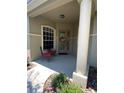 Covered front porch with seating and decorative wreath at 102 Jardin Ln, Winter Haven, FL 33884