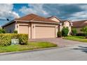 Home with two car garage and lush landscaping at 4568 Back Nine Dr, Winter Haven, FL 33884