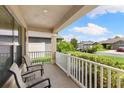 Covered front porch with seating area, overlooking the street at 6421 Alamanda Hills Dr, Lakeland, FL 33813