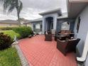 Brick patio with seating area and landscaping at 657 Sweetwater Way, Haines City, FL 33844