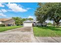 Single-story house featuring a two-car garage and well-maintained lawn at 4353 Dinner Lake Dr, Lake Wales, FL 33859