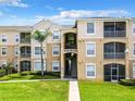 Two-story condo building with balconies and landscaping at 8105 Coconut Palm Way # 204, Kissimmee, FL 34747