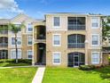 Two-story condo building with balconies and landscaping at 8105 Coconut Palm Way # 204, Kissimmee, FL 34747
