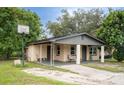 Brick home with covered porch, mature landscaping, and a basketball hoop at 2920 Gause St, Bartow, FL 33830