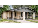 Brick home with covered porch, mature landscaping, and a basketball hoop at 2920 Gause St, Bartow, FL 33830
