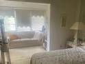 Main bedroom with access to sunroom at 400 El Camino Dr # 223, Winter Haven, FL 33884