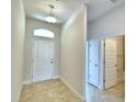 Entryway with tile flooring, neutral walls, and access to bathroom at 1234 Tagliamento Ln, Haines City, FL 33844