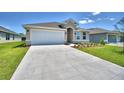 Single-story home with attached garage and driveway at 1269 Tagliamento Ln, Haines City, FL 33844