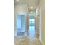 Bright hallway with tile flooring, leading to bedrooms and other rooms at 1253 Tagliamento Ln, Haines City, FL 33844