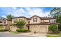 Two-story townhome with attached garage and landscaping at 8153 Roseville Rd, Davenport, FL 33896