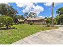 Brick home with a two-car garage and a spacious yard at 9011 Whipperwill Ln, Haines City, FL 33844