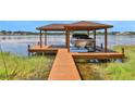 Private dock with covered boat lift at 1441 S Lake Roy Dr, Winter Haven, FL 33884
