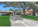 House exterior showcasing landscaping and driveway at 1441 S Lake Roy Dr, Winter Haven, FL 33884