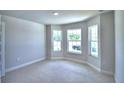 Spacious bedroom with bay window, neutral walls, and plush carpeting at 1155 Berry Ln, Davenport, FL 33837