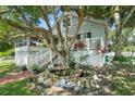 Charming house with wrap-around porch, landscaping, and pond feature at 319 N Wales Dr, Lake Wales, FL 33853