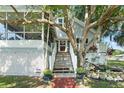 House exterior with stairs, landscaping, and white picket fence at 319 N Wales Dr, Lake Wales, FL 33853