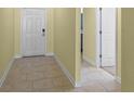 Bright entryway with tile flooring and access to adjacent rooms at 625 Eisenhower St, Bartow, FL 33830