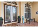 Front entrance with double doors and a welcoming bench at 4496 Strathmore Dr, Lake Wales, FL 33859