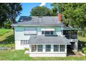 Aerial view of a light green house with a screened porch at 420 W Gates Ave, Lake Hamilton, FL 33851