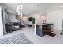 Open floor plan with kitchen island, living room, and staircase at 339 Lake Smart Cir, Winter Haven, FL 33881