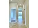 Bright hallway with tile flooring and access to bedrooms and other rooms at 1222 Tagliamento Ln, Haines City, FL 33844