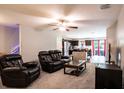 Living room with reclining furniture and view of the kitchen at 997 Pearly Ridge Ln, Lakeland, FL 33809