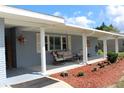 Covered porch with rocking chairs and seating area at 6750 Winterset Gardens Rd, Winter Haven, FL 33884