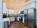 Modern kitchen with stainless steel appliances and white cabinets at 169 Violet Ct, Kissimmee, FL 34759