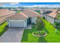 Gray house with a two-car garage and manicured lawn at 2505 Salzburg Loop, Winter Haven, FL 33884